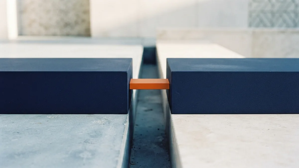 A linked payment and delivery process Minimal navy blocks linked across a gap to represent a secure exchange